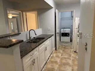 a kitchen with sink and refrigerator