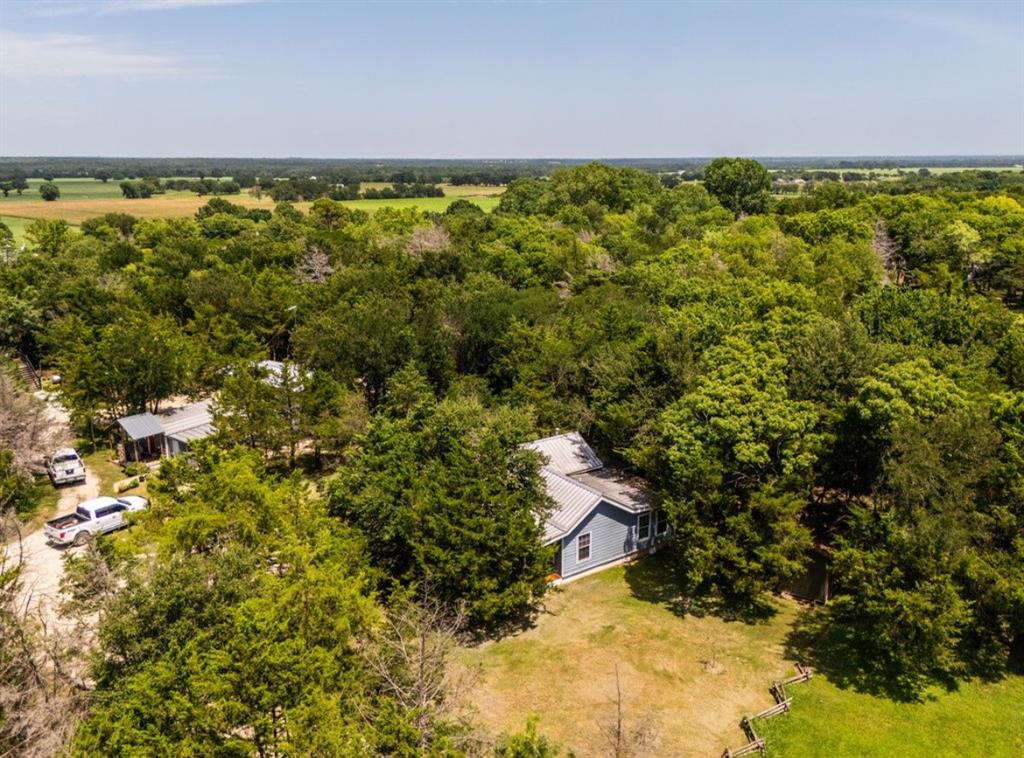 14275 Gholson Road Gholson, TX 76705 - Photo 19 of 22 Aerial perspective showcasing two properties surrounded by abundant mature trees and expansive green spaces