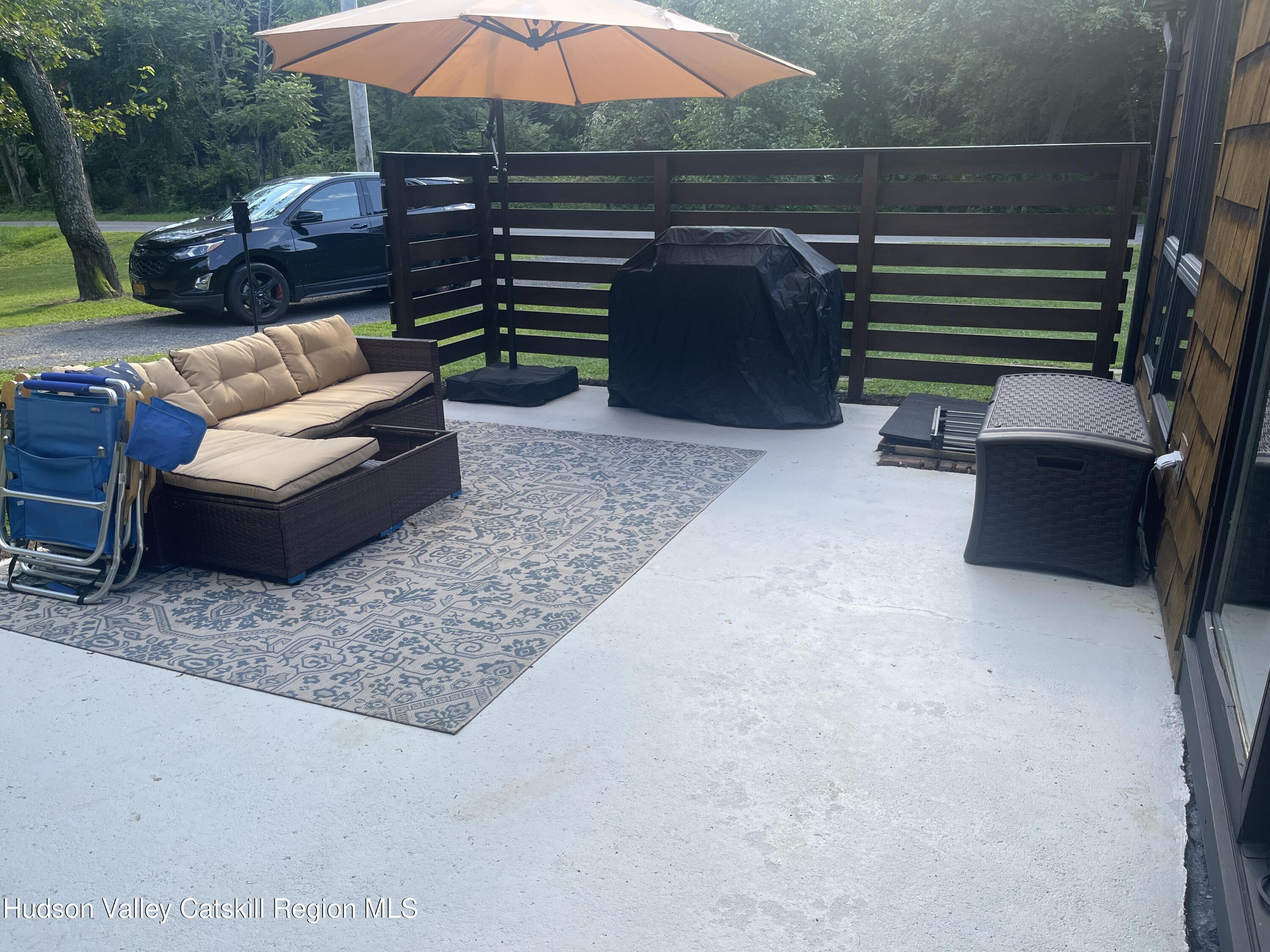 5538 Cauterskill Road Catskill, NY 12414 - Photo 8 of 23 a view of patio with couches table and chairs under an umbrella