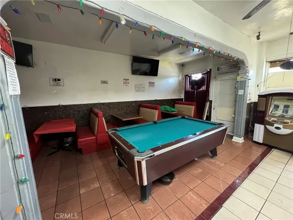 a room with pool table and a flat screen tv