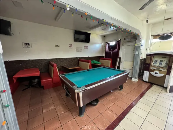 a room with pool table and a flat screen tv