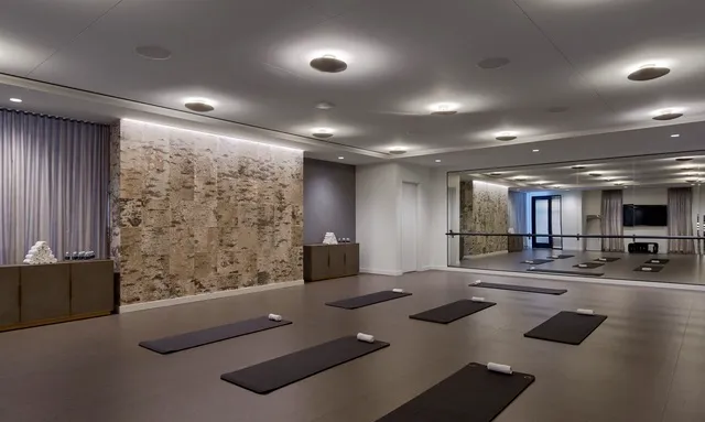 a room with gym equipment and a large window