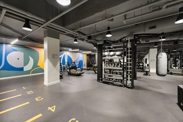 a gym room with lots of gym equipment