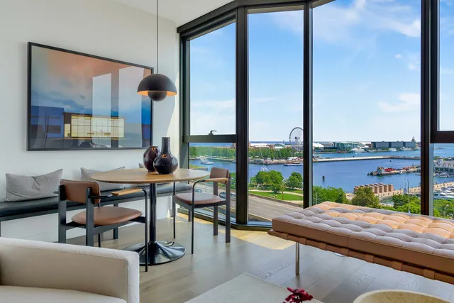 a living room with a table or chairs and a floor to ceiling window