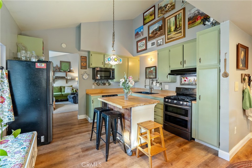 8892 Palomar Avenue Atascadero, CA 93422 - Photo 11 of 49 Enjoy ample counter space with butcher block surfaces and a functional wraparound cabinet layout.