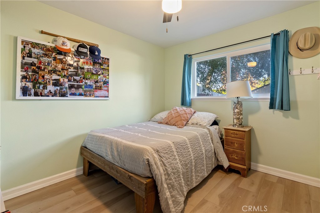 8892 Palomar Avenue Atascadero, CA 93422 - Photo 17 of 49 Bedroom 3 features a ceiling fan and laminate flooring, offering a bright and comfortable space.