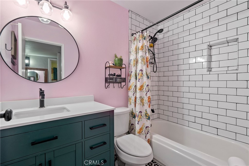 8892 Palomar Avenue Atascadero, CA 93422 - Photo 19 of 49 Beautiful white subway tiles surround the tub and shower combo, complemented by a floating mirror and a solid-surface vanity.