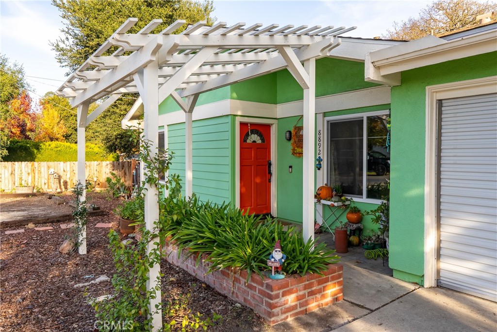 8892 Palomar Avenue Atascadero, CA 93422 - Photo 6 of 49 Enter through the red door beneath the pergola, inviting you inside.