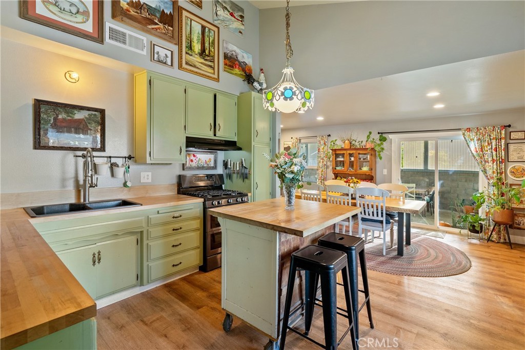 8892 Palomar Avenue Atascadero, CA 93422 - Photo 10 of 49 Get ready to cook and entertain in this open kitchen and dining area, featuring vaulted ceilings that enhance the spacious, inviting atmosphere.