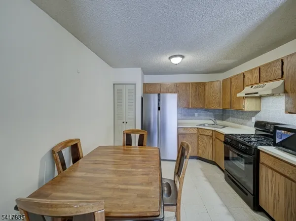 a kitchen with refrigerator and stove
