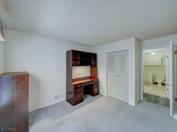 an empty room with furniture and a fireplace