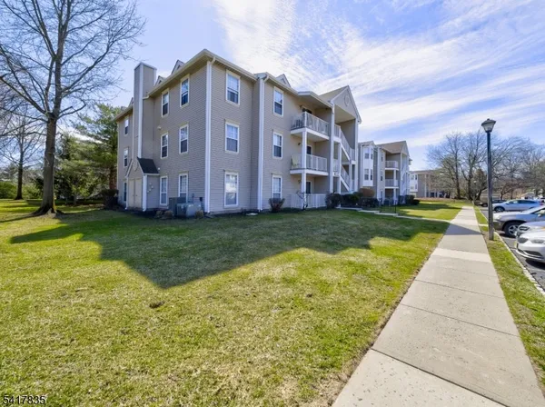 a view of city with tall buildings and a cars parked on road