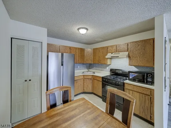 a kitchen with stainless steel appliances a refrigerator stove and sink