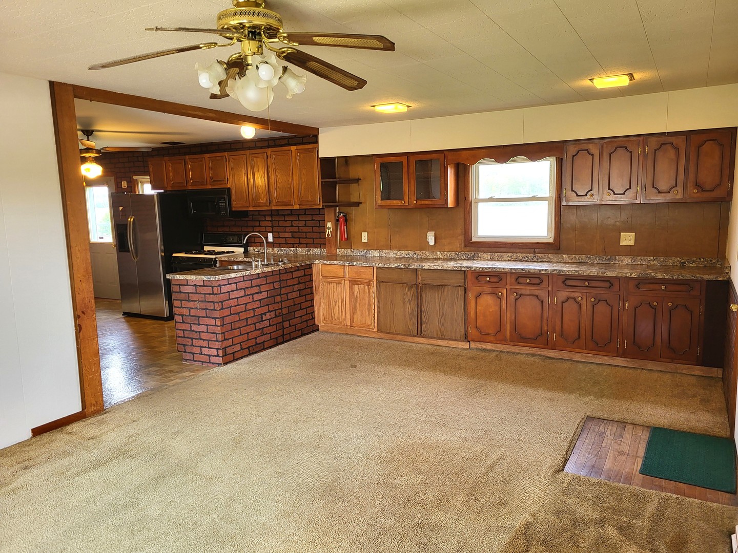5890 Highway 2 Oregon, IL 61061 - Photo 6 of 18 a large kitchen with stainless steel appliances granite countertop a sink and cabinets