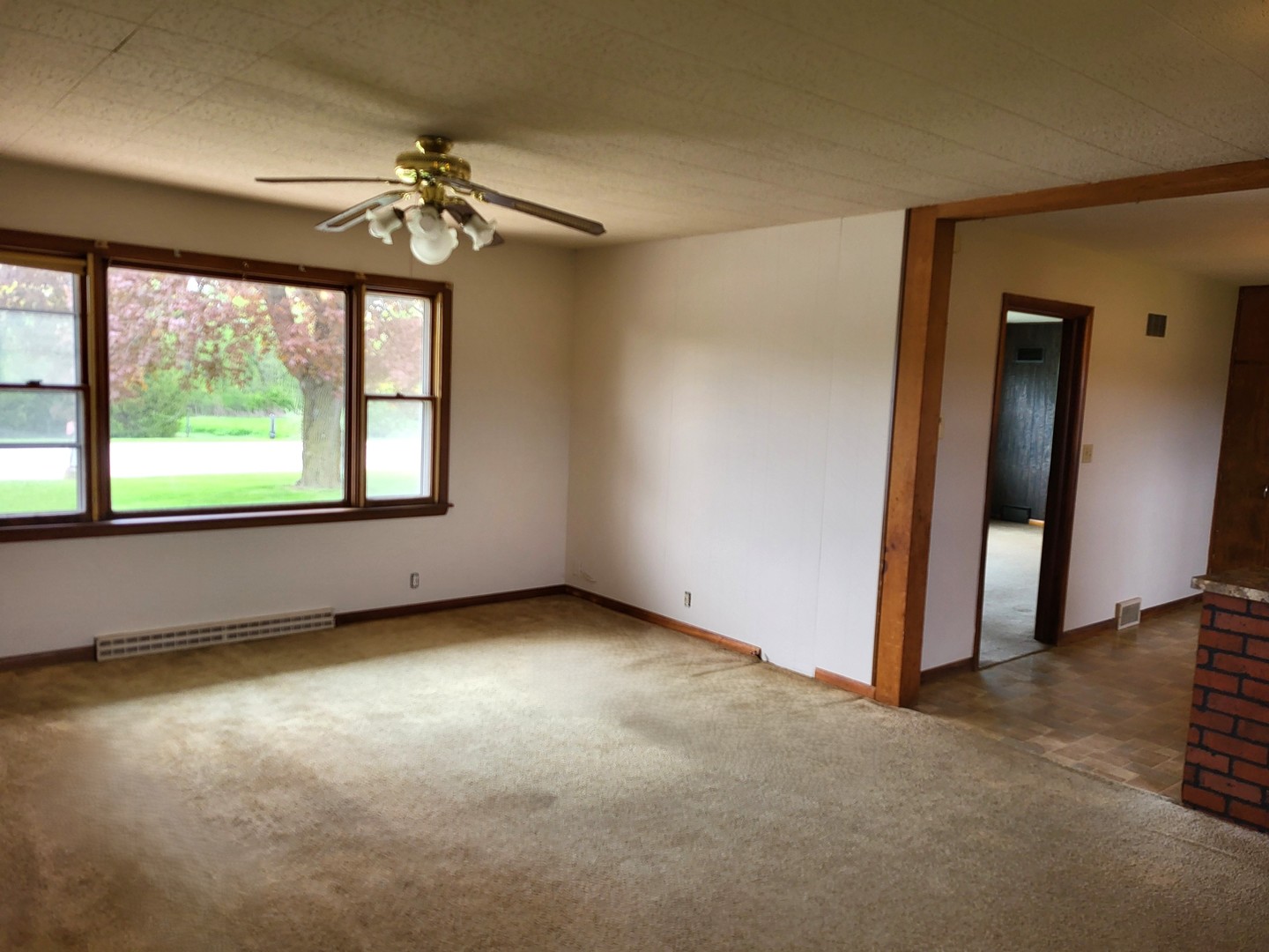 5890 Highway 2 Oregon, IL 61061 - Photo 7 of 18 an empty room with windows and chandelier fan