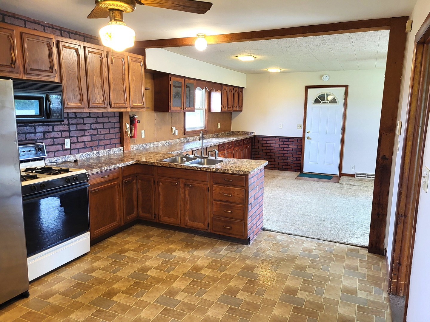5890 Highway 2 Oregon, IL 61061 - Photo 8 of 18 a kitchen with stainless steel appliances granite countertop a stove sink and cabinets