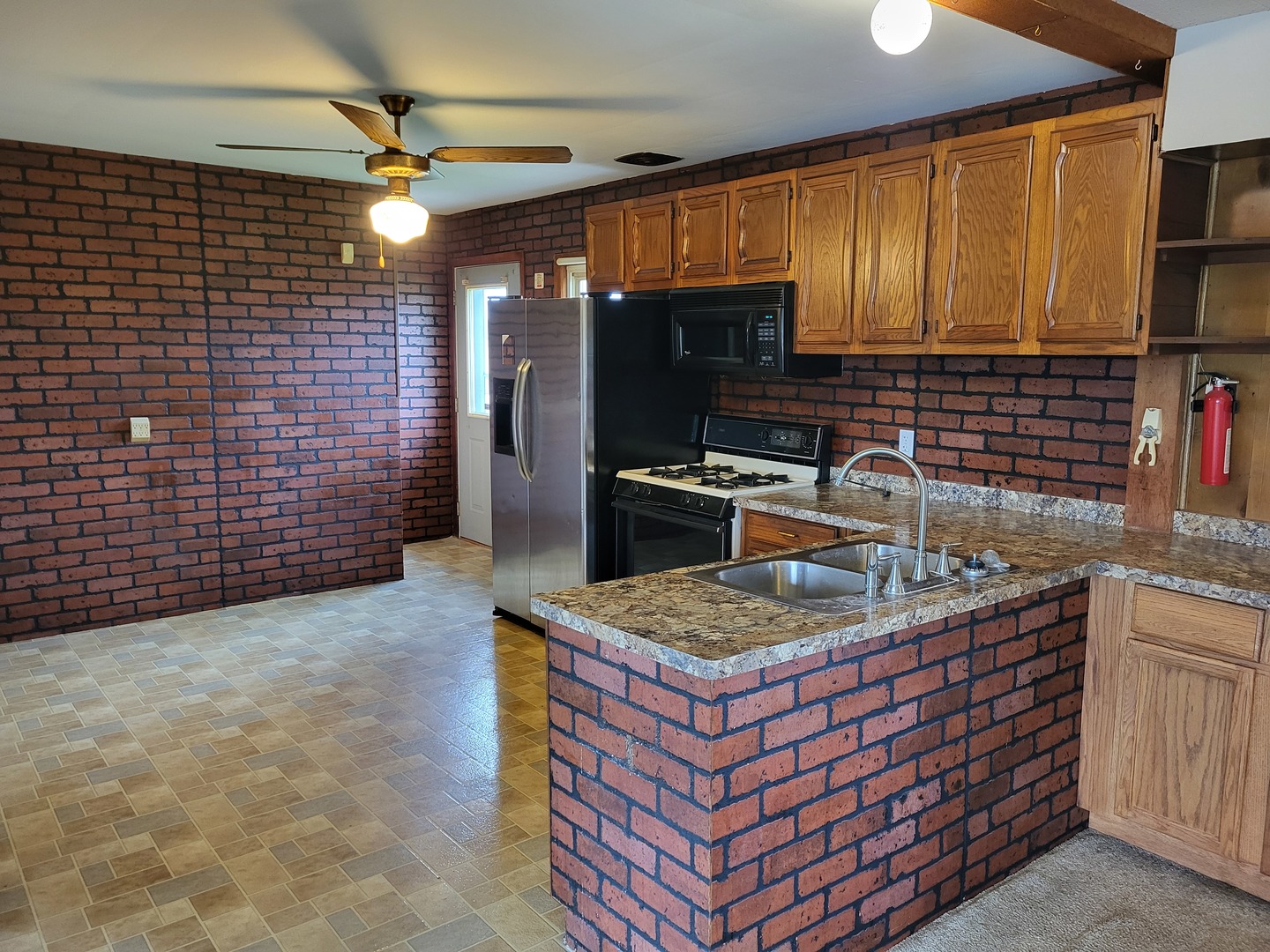 5890 Highway 2 Oregon, IL 61061 - Photo 9 of 18 a kitchen with stainless steel appliances granite countertop a sink stove and refrigerator