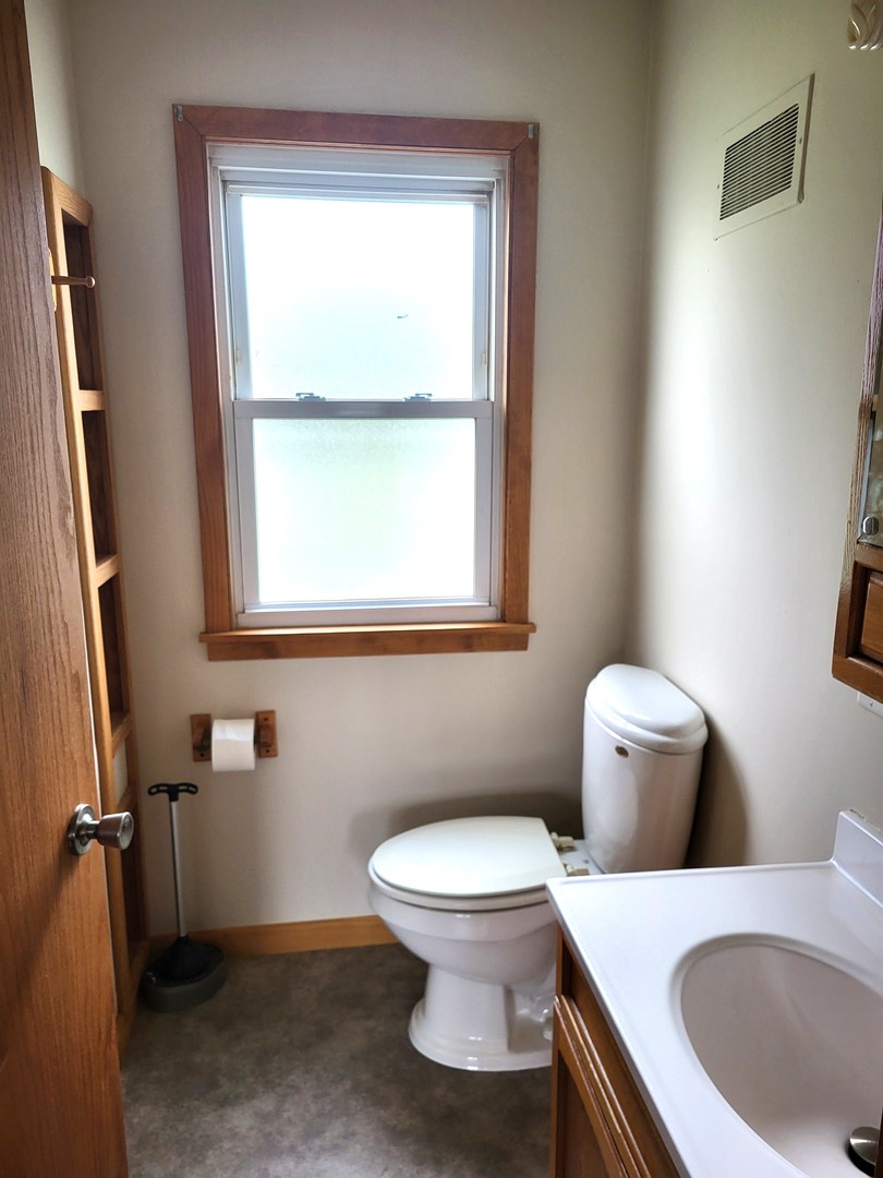 5890 Highway 2 Oregon, IL 61061 - Photo 10 of 18 a white toilet sitting next to a bathroom sink