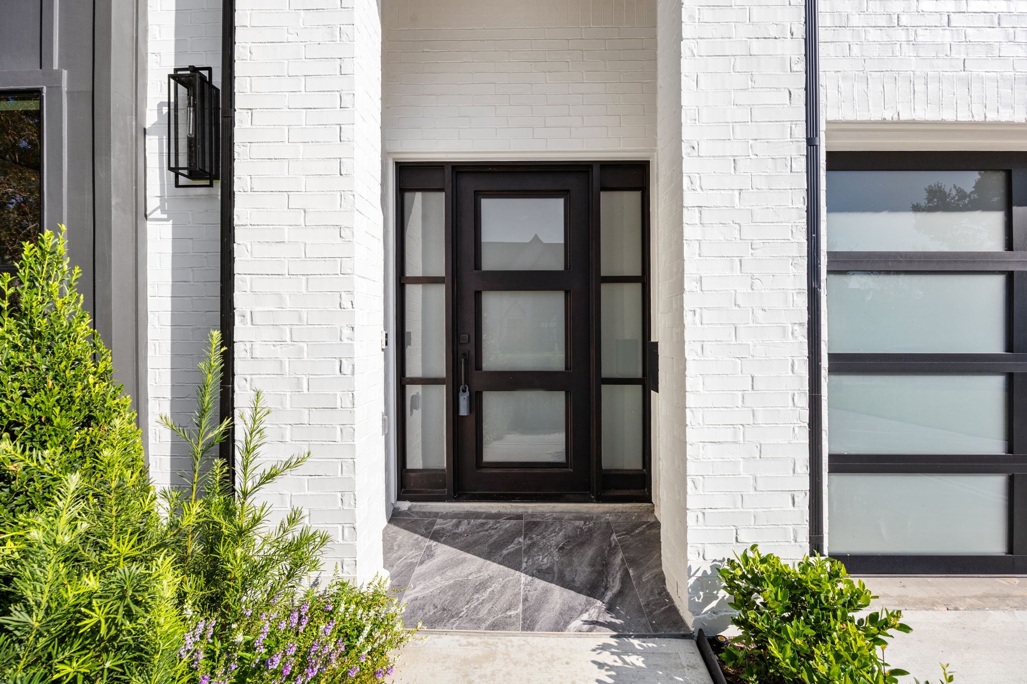 1032 West 41st Street Houston, TX 77018 - Photo 4 of 46 Front Entry offers a custom metal door w/ frosted glass for privacy & designer selected lanterns.