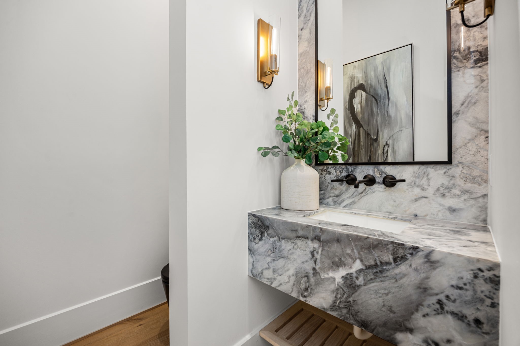 1032 West 41st Street Houston, TX 77018 - Photo 7 of 46 Stunning Powder room offers Dolomite natural stone vanity slab & tall backsplash. High-end and sleek modern black commode. Towel rack under vanity.