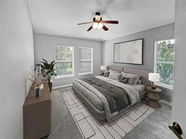 a bedroom with a large bed and a chandelier