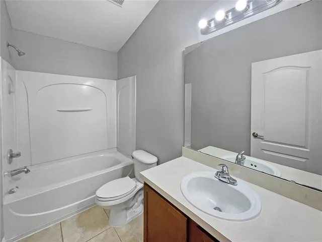 a bathroom with a sink toilet tub and shower