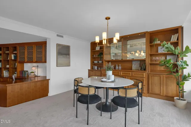 a view of a dining room with furniture and chandelier