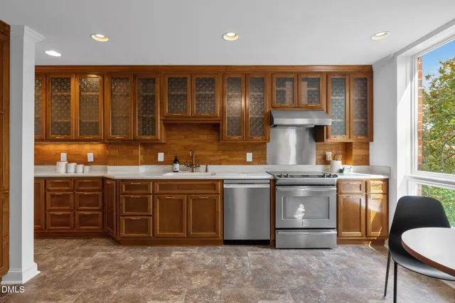 a kitchen with stainless steel appliances granite countertop a refrigerator and a sink
