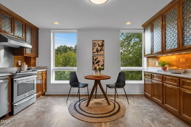 a kitchen with a table and chairs in it