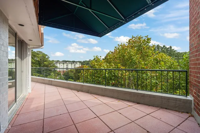 a view of a chairs and table in the balcony