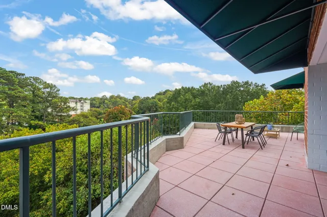 a backyard of a house with barbeque oven table and chairs