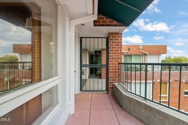 a view of a house with wooden fence