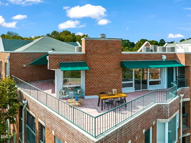 an aerial view of a house with balcony and outdoor space
