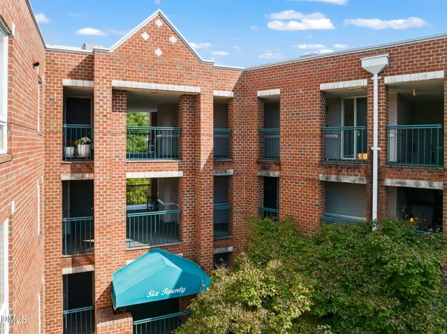 a front view of a residential apartment building with a yard