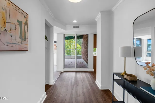 a view of hallway with furniture and wooden floor