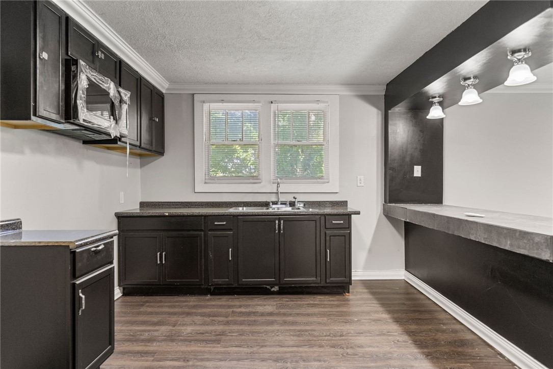 109 Farmer Street Anderson, SC 29621 - Photo 11 of 31 Functional kitchen offers ample cabinetry, granite counters, and wood-look flooring for easy maintenance.