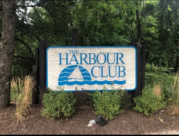 a sign broad in front of a tree