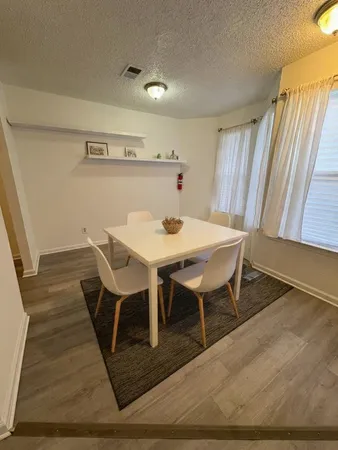 a view of a dining room with furniture and wooden floor