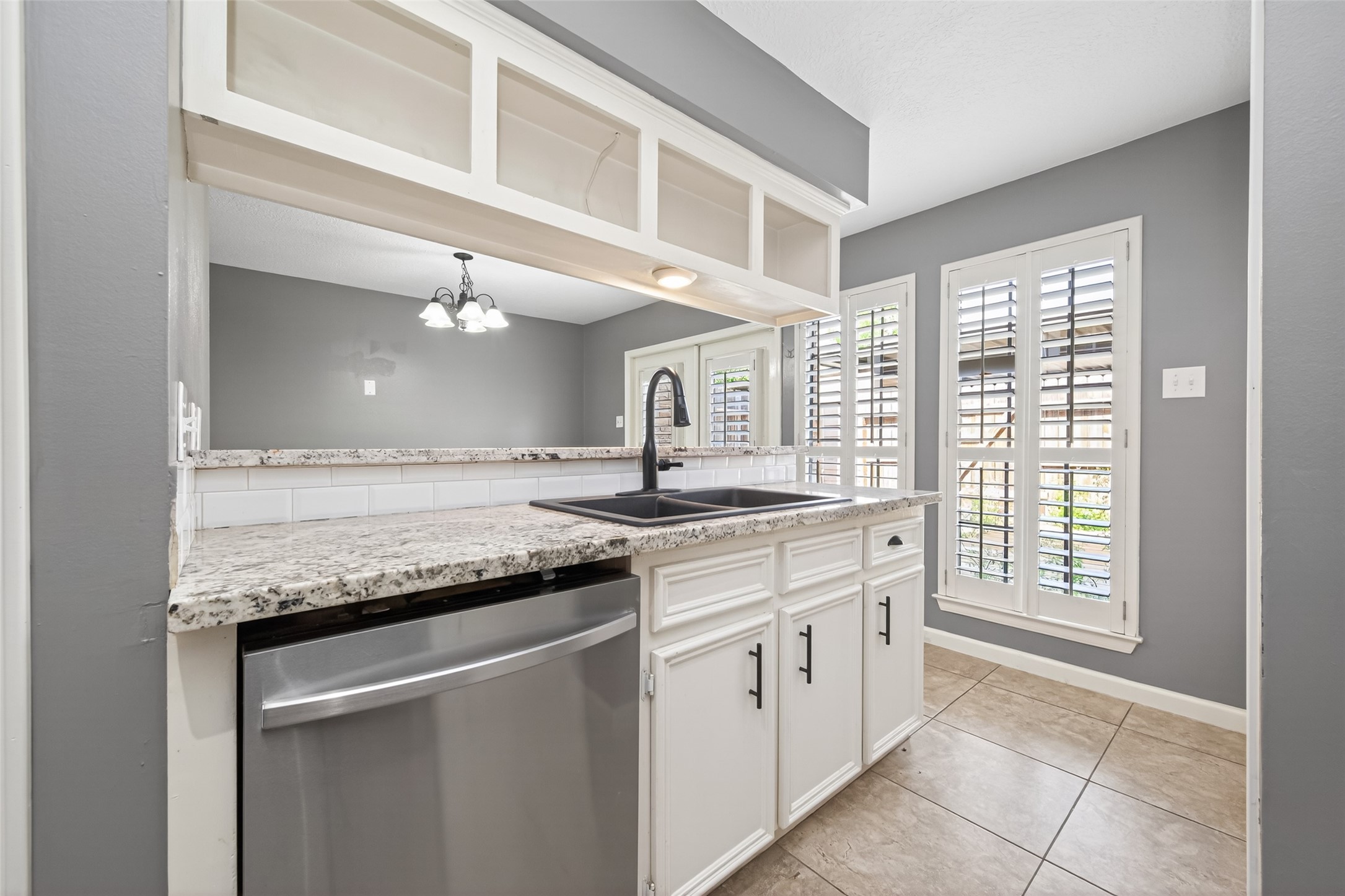 6700 Richardson Road, Unit 305 Houston, TX 77069 - Photo 16 of 46 a kitchen with granite countertop a sink and cabinets