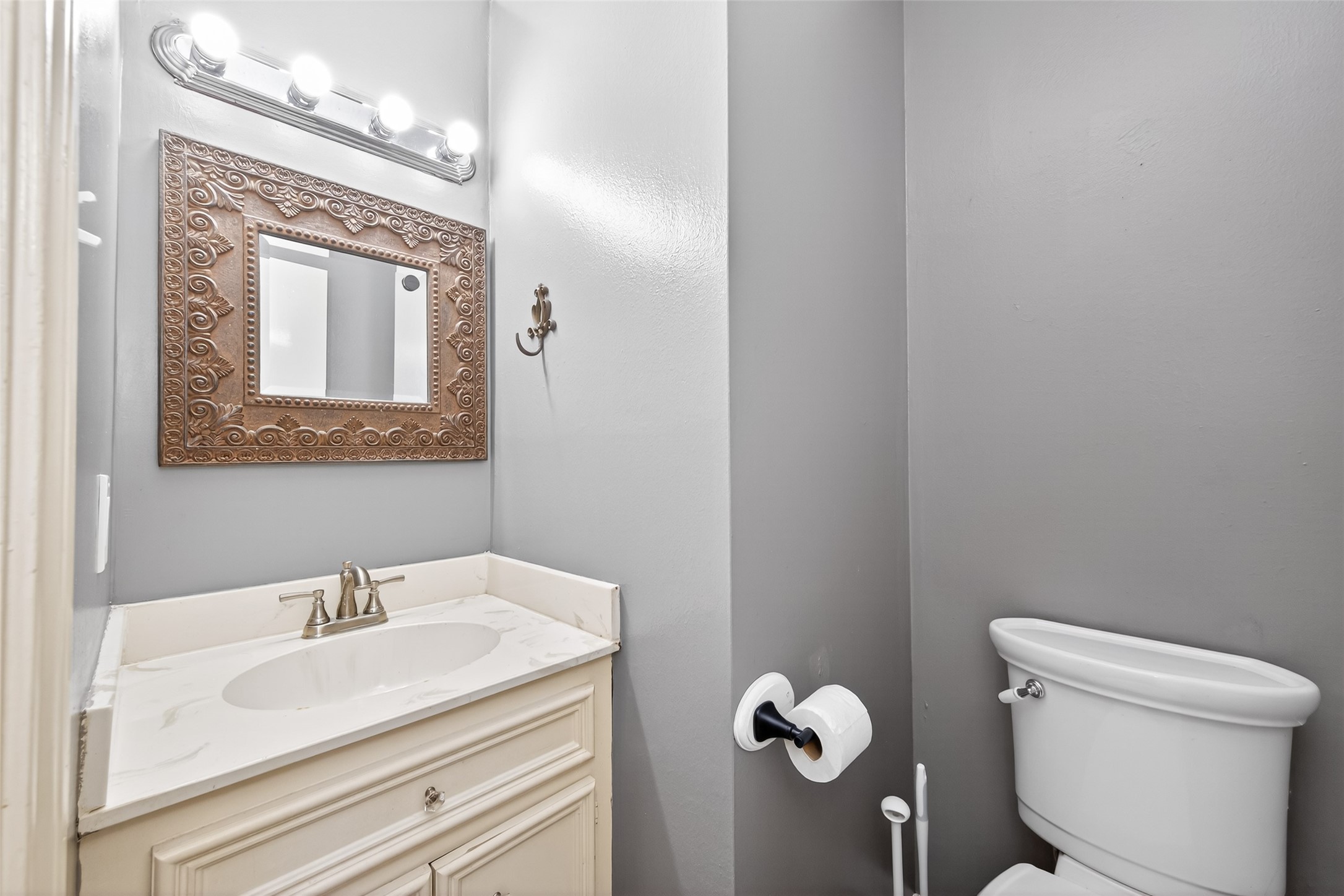 6700 Richardson Road, Unit 305 Houston, TX 77069 - Photo 19 of 46 a bathroom with a sink mirror and toilet