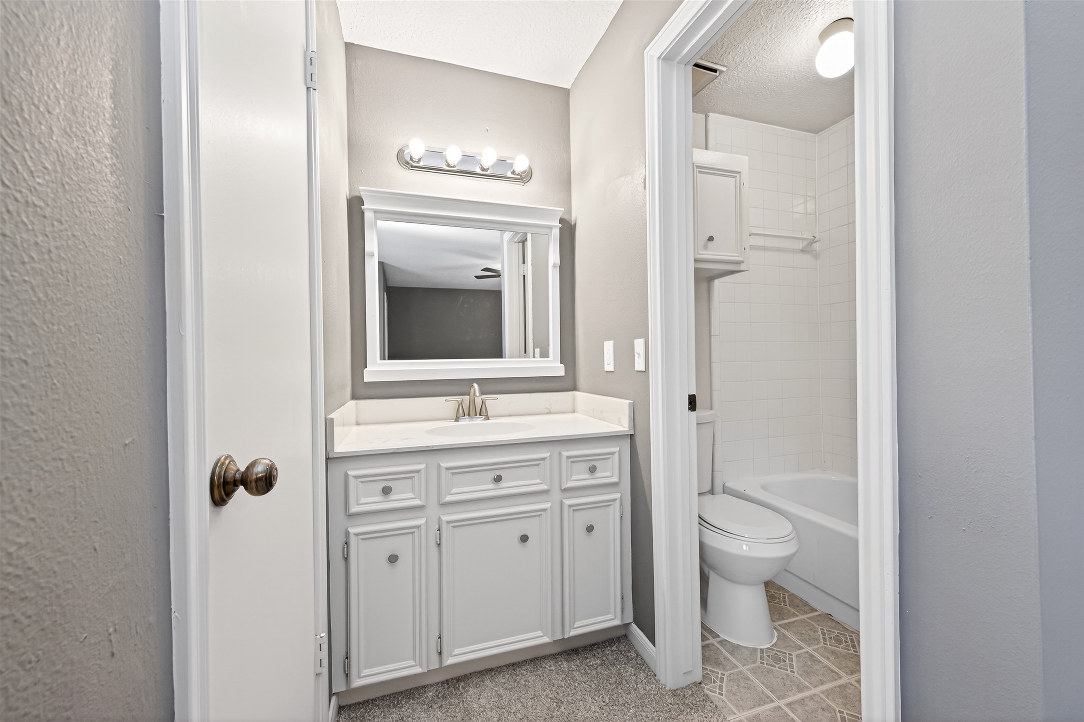 6700 Richardson Road, Unit 305 Houston, TX 77069 - Photo 33 of 46 a spacious bathroom with a granite countertop toilet a sink and a mirror