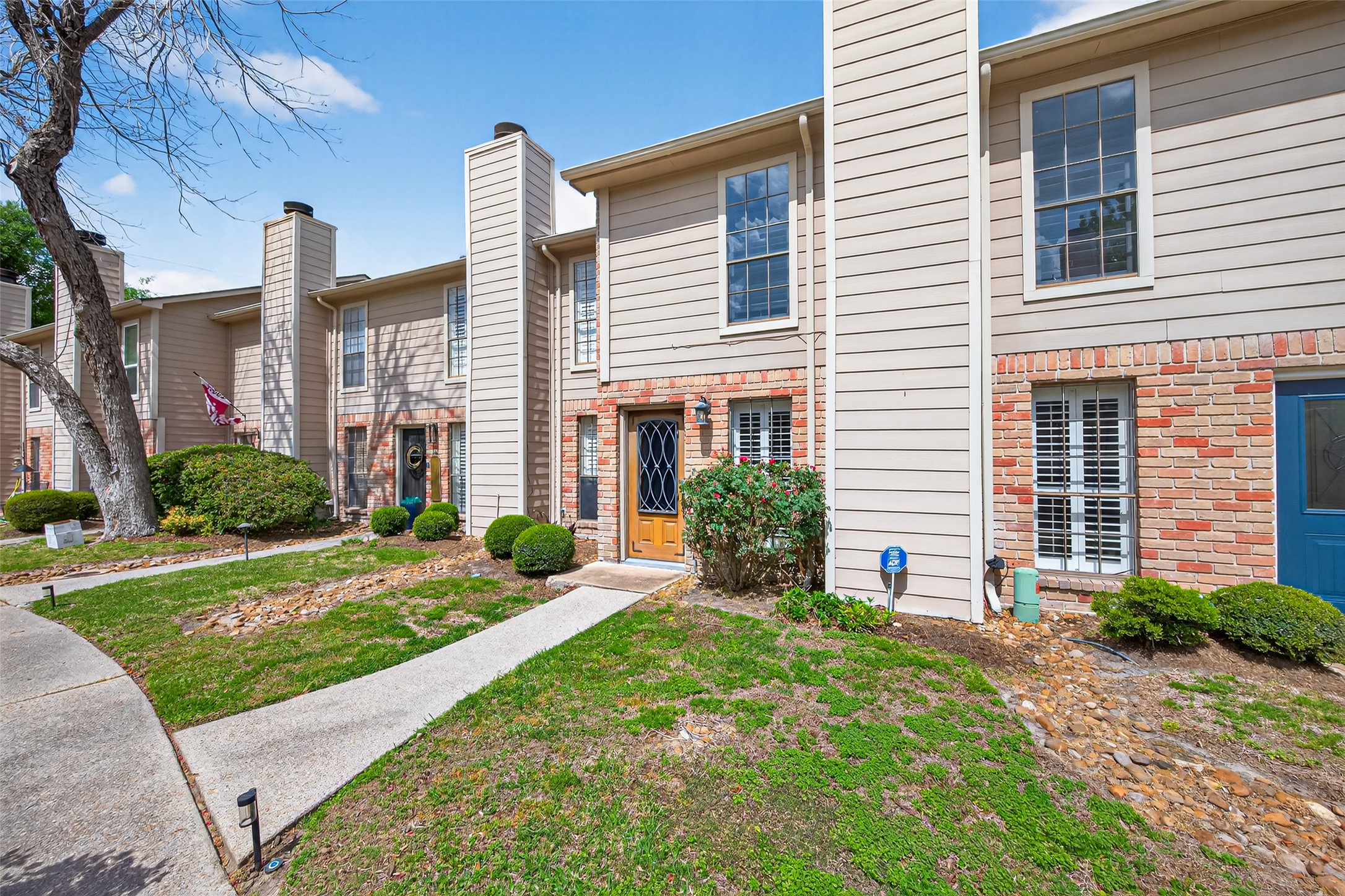 6700 Richardson Road, Unit 305 Houston, TX 77069 - Photo 44 of 46 a front view of a house with a yard and potted plants