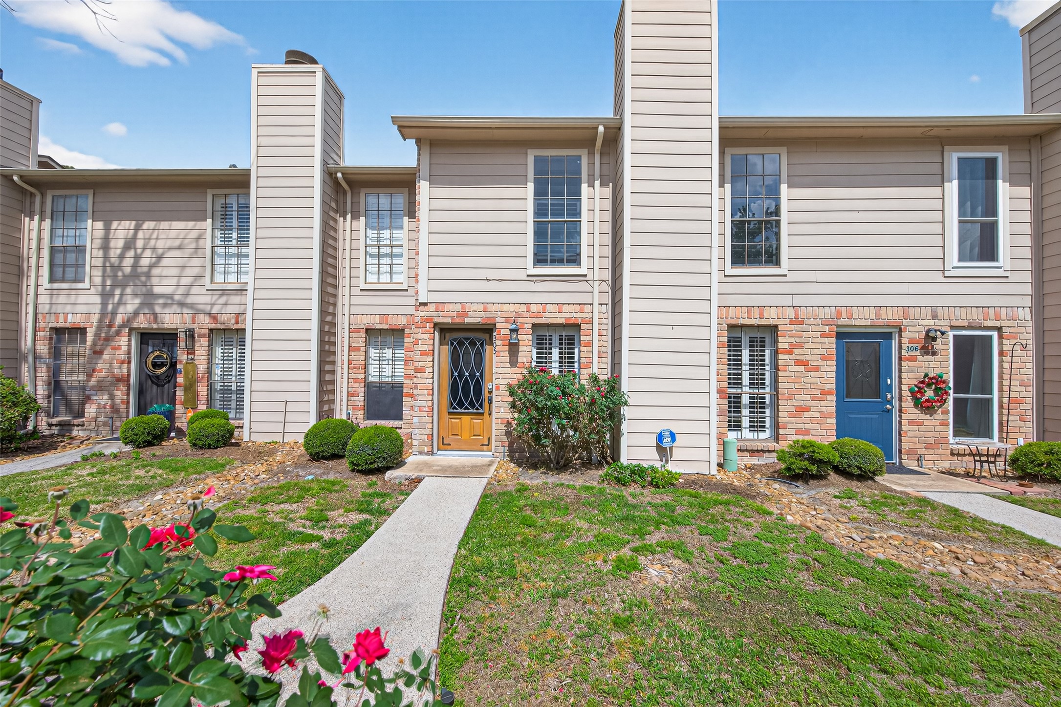 6700 Richardson Road, Unit 305 Houston, TX 77069 - Photo 45 of 46 a front view of a house with yard and outdoor seating