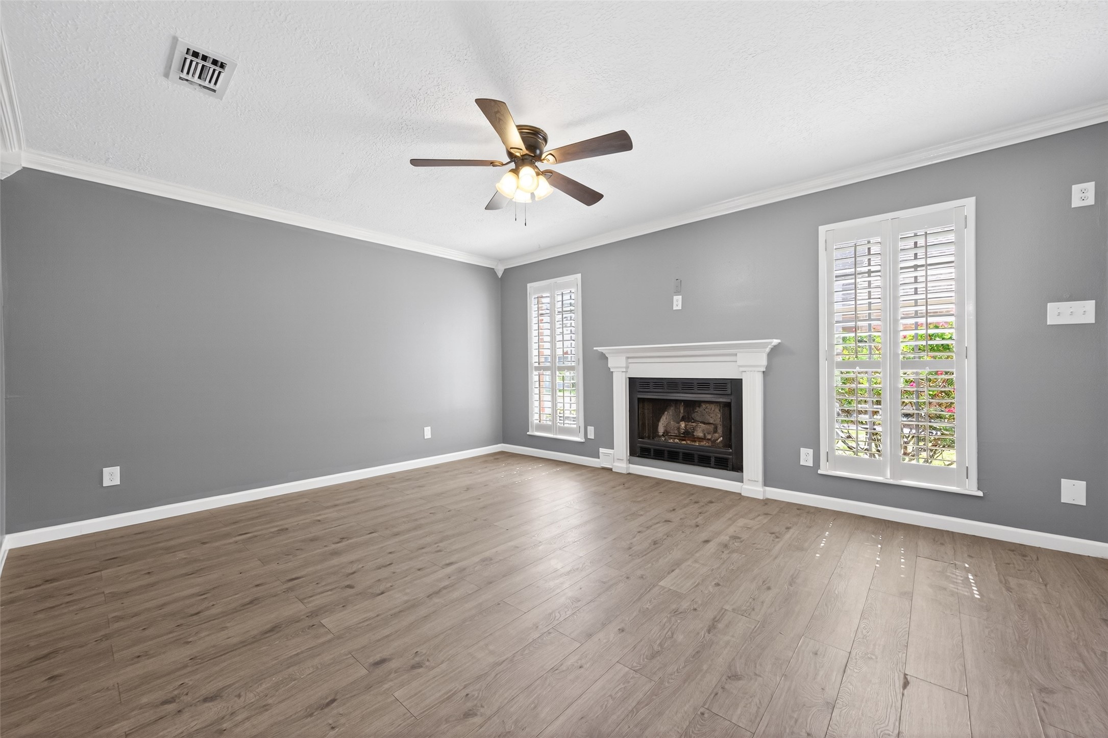 6700 Richardson Road, Unit 305 Houston, TX 77069 - Photo 5 of 46 a view of an empty room with wooden floor fireplace and a window