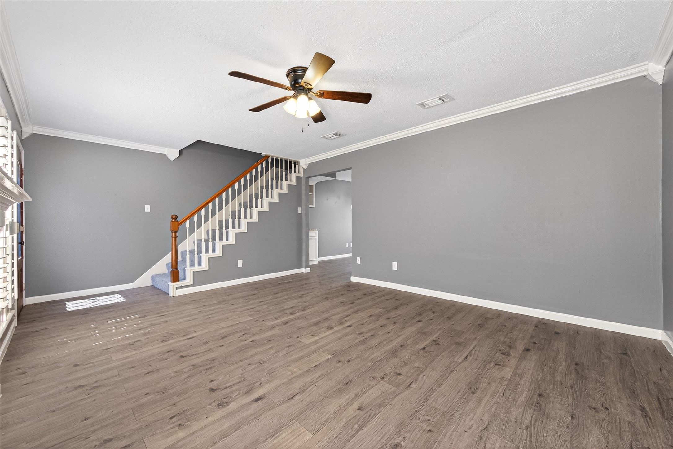 6700 Richardson Road, Unit 305 Houston, TX 77069 - Photo 7 of 46 a view of an empty room with wooden floor and a ceiling fan
