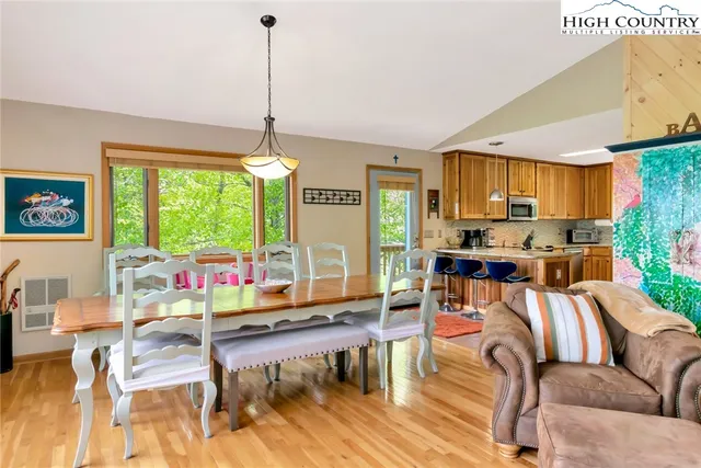 a living room with furniture fireplace and a large window