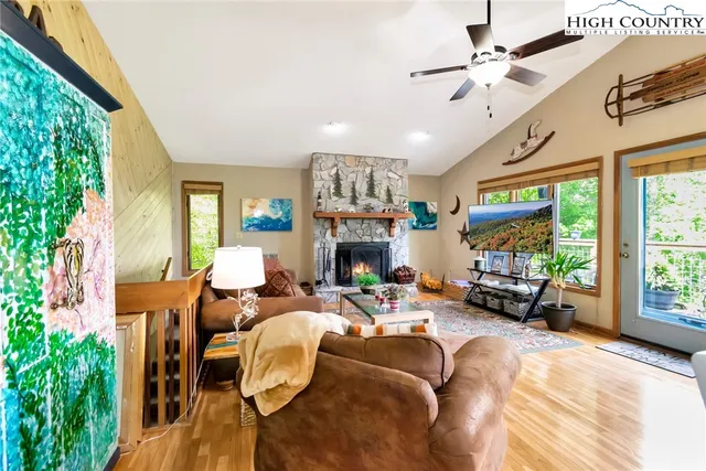 a living room with furniture large window and a fireplace
