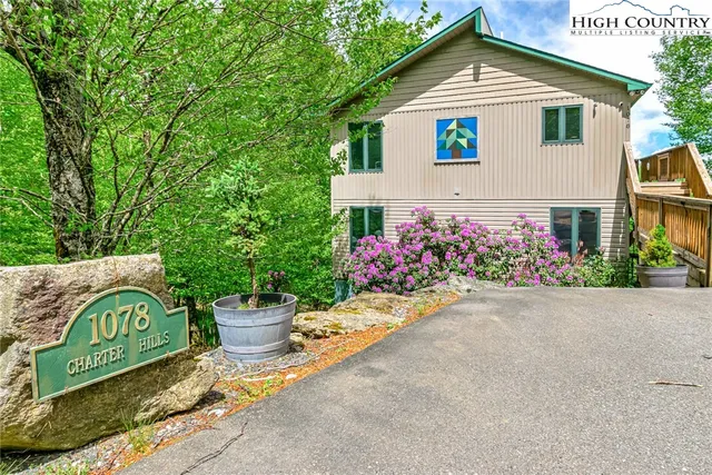 a kitchen with stainless steel appliances granite countertop a stove a sink dishwasher and a refrigerator with wooden cabinets