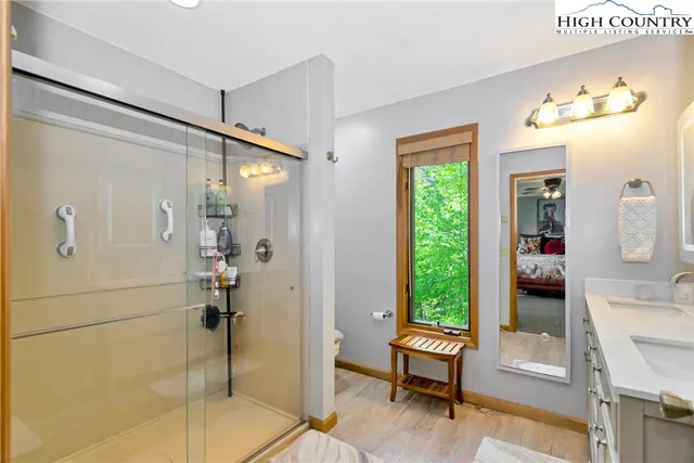 a bathroom with a sink a toilet and shower