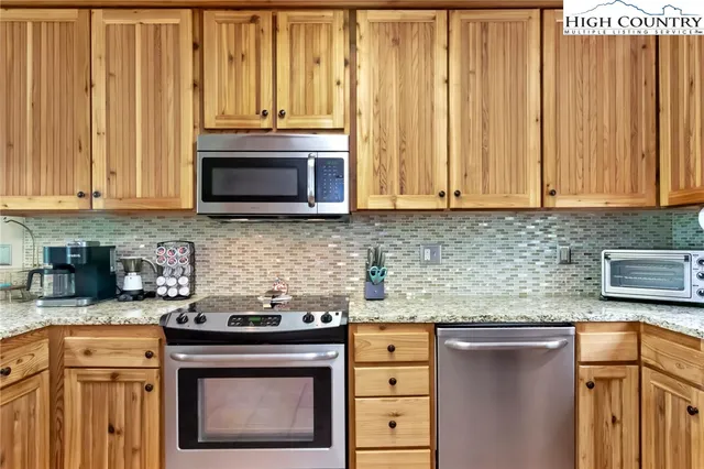 a kitchen with washing machine and a sink
